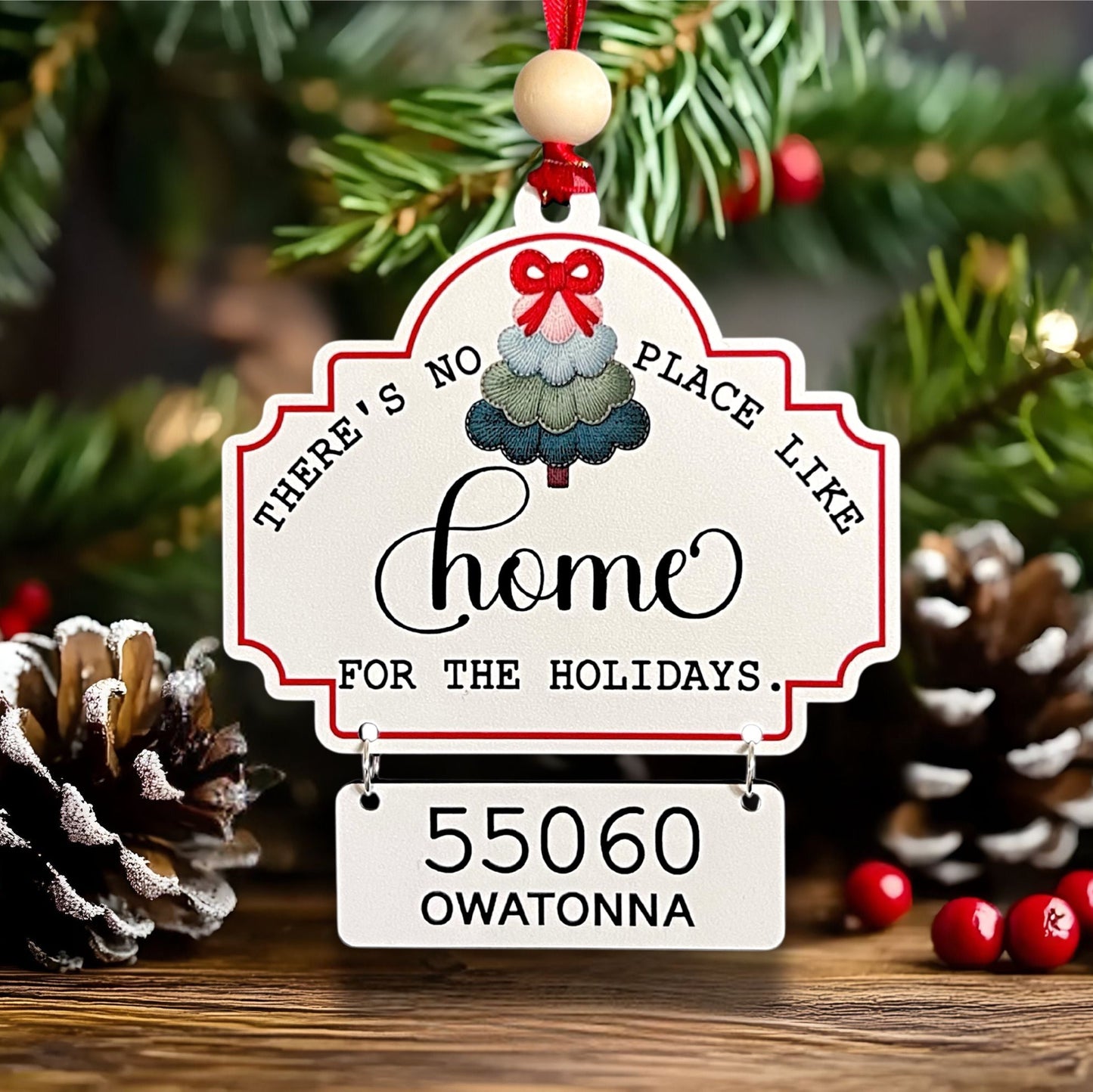 Decorative Christmas ornament with text and house number against a festive background