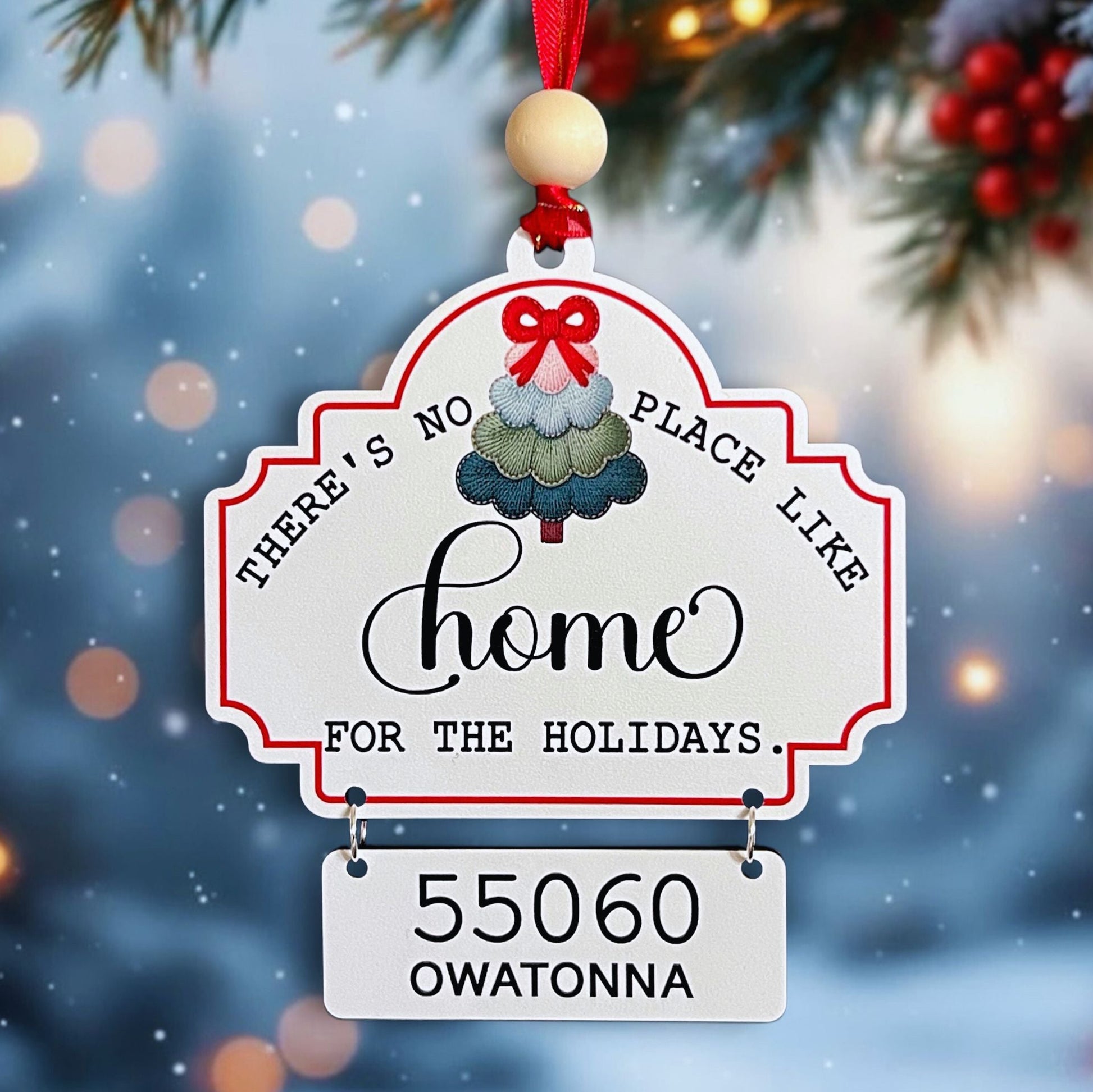 There's no place like home for the holidays zip code ornament with colorful tree and hanging sign with city and zip code.