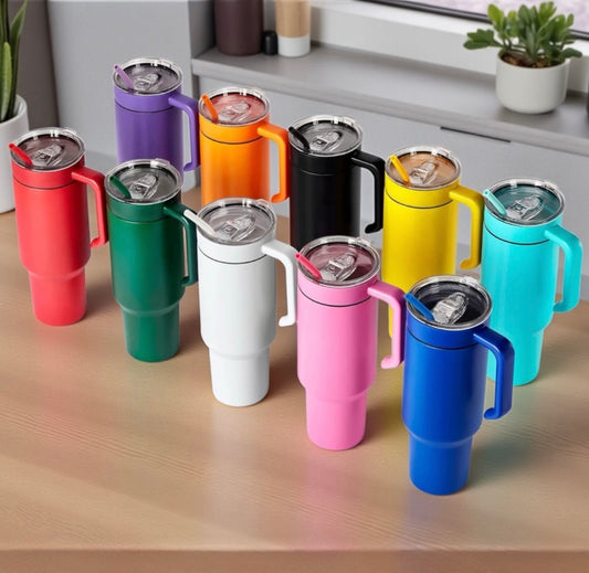Colorful insulated travel mugs with matching handles on a wooden surface with a kitchen background.