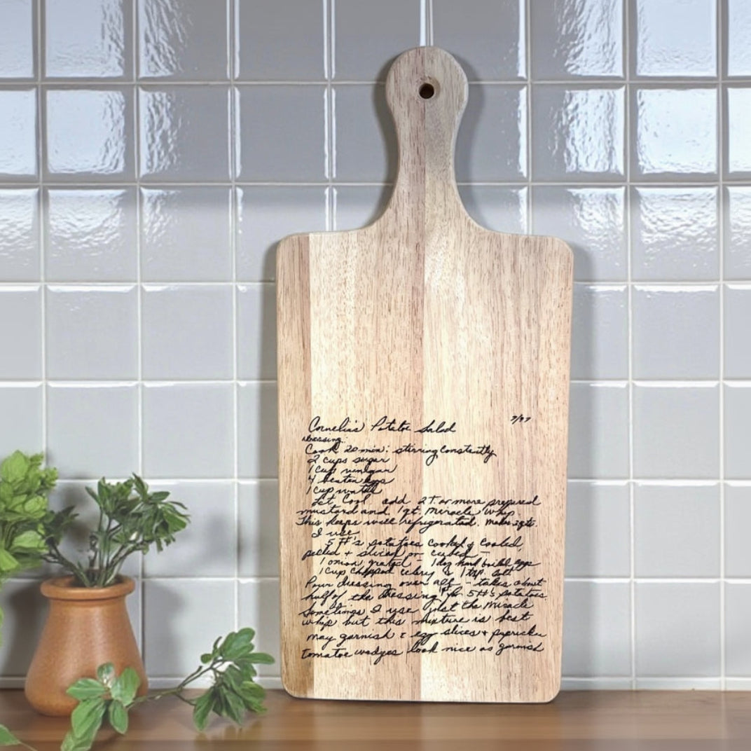 Wooden cutting board with engraved recipe on a tiled wall background