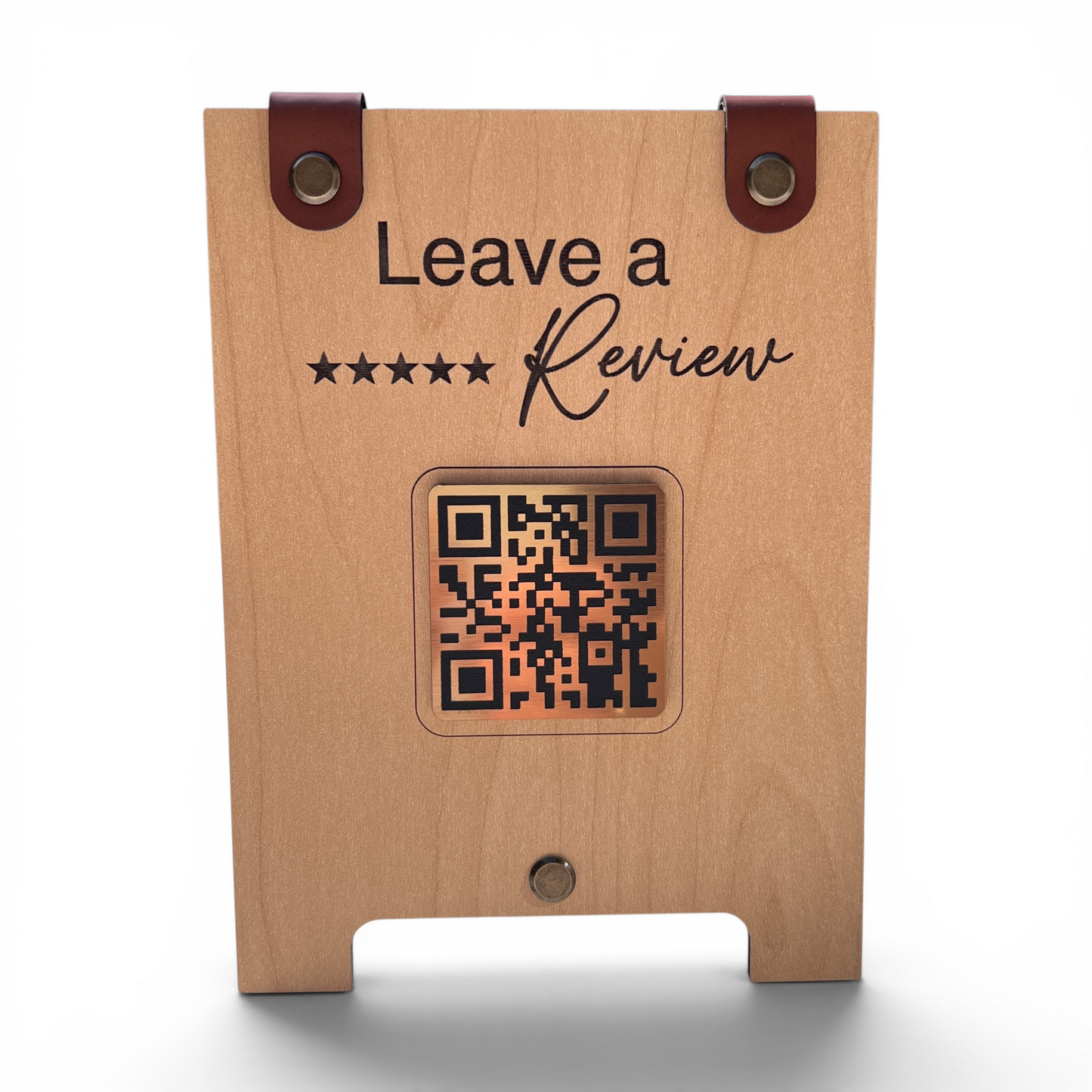A wooden review stand with a natural wood finish, featuring two brown leather strap loops at the top, a black engraved  'Leave a Review' graphic with a 5 star rating, and a central QR code window. The stand is shown on a clean white background with a soft shadow underneath.