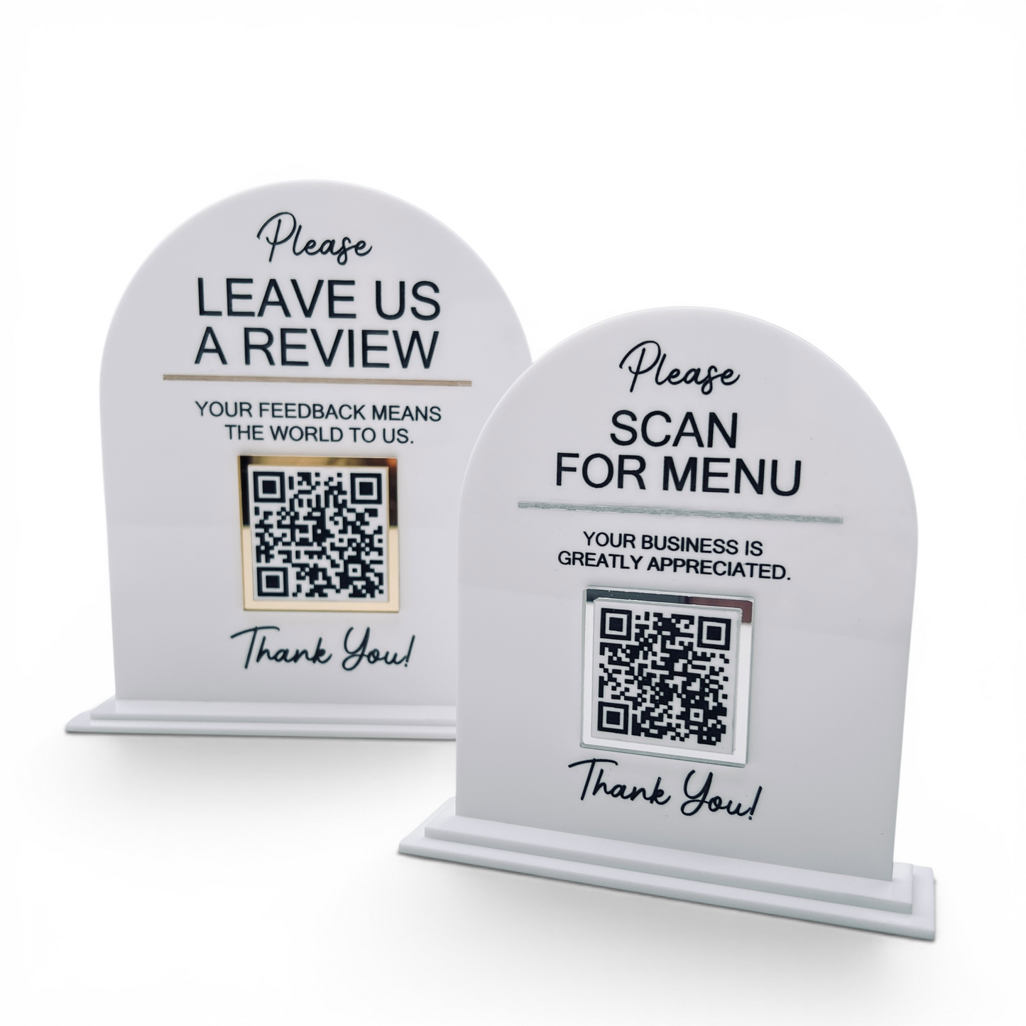 Two white arched tabletop review signs on a light gray background. One sign says 'LEAVE US A REVIEW' with a QR code, and the other says 'SCAN FOR MENU' with a QR code and 'Thank You!' below.