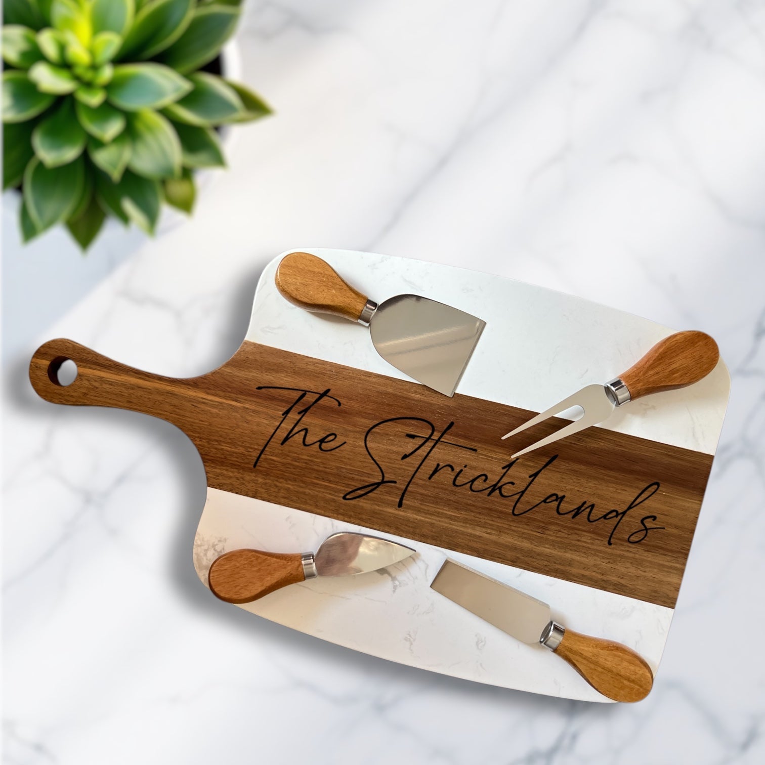 Custom wood and marble charcuterie board engraved with last name